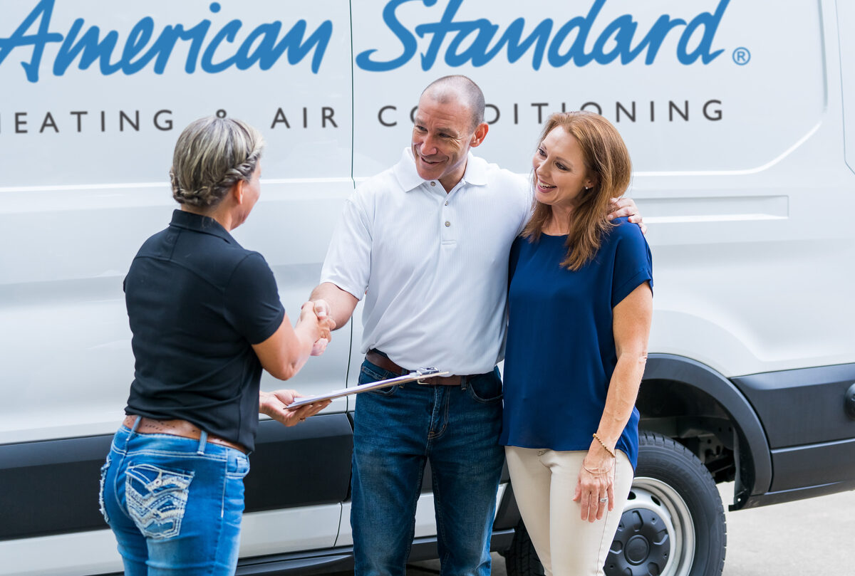 american standard van with hvac tech standing in front of it